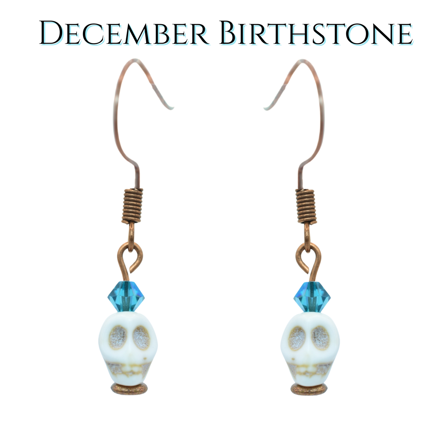 Skull-shaped earrings with teal blue crystal beads on a white background, labeled 'December Birthstone'.