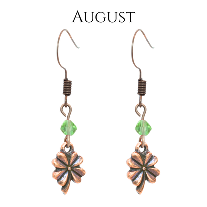 earrings featuring antique copper four leaf clover charms and Austrian crystal beads in August birthstone colors