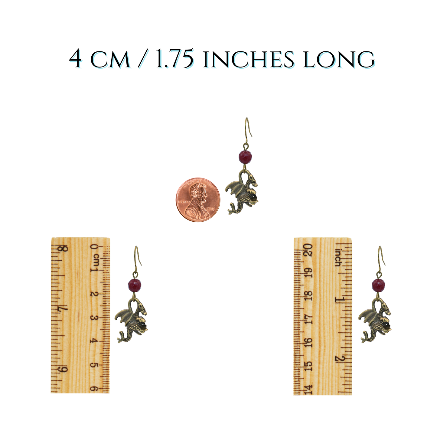 Pair of earrings with a penny and ruler for scale on a white background