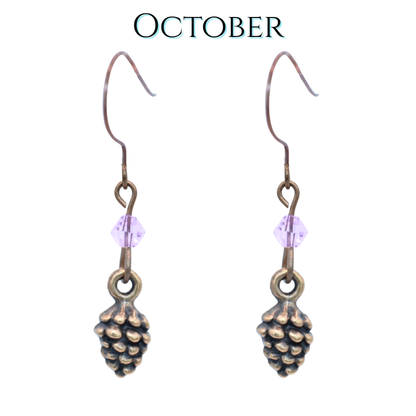 Pinecone-shaped earrings with light pink crystal beads on a white background, labeled 'October'.