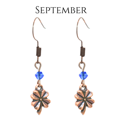 earrings featuring antique copper four leaf clover charms and Austrian crystal beads in September birthstone colors