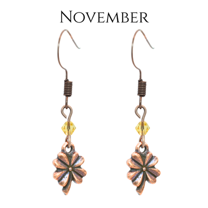 earrings featuring antique copper four leaf clover charms and Austrian crystal beads in November birthstone colors