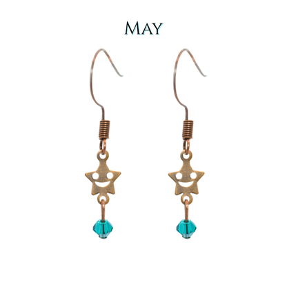 Star-shaped earrings with emerald green crystal beads on a white background, labeled 'MAY'.