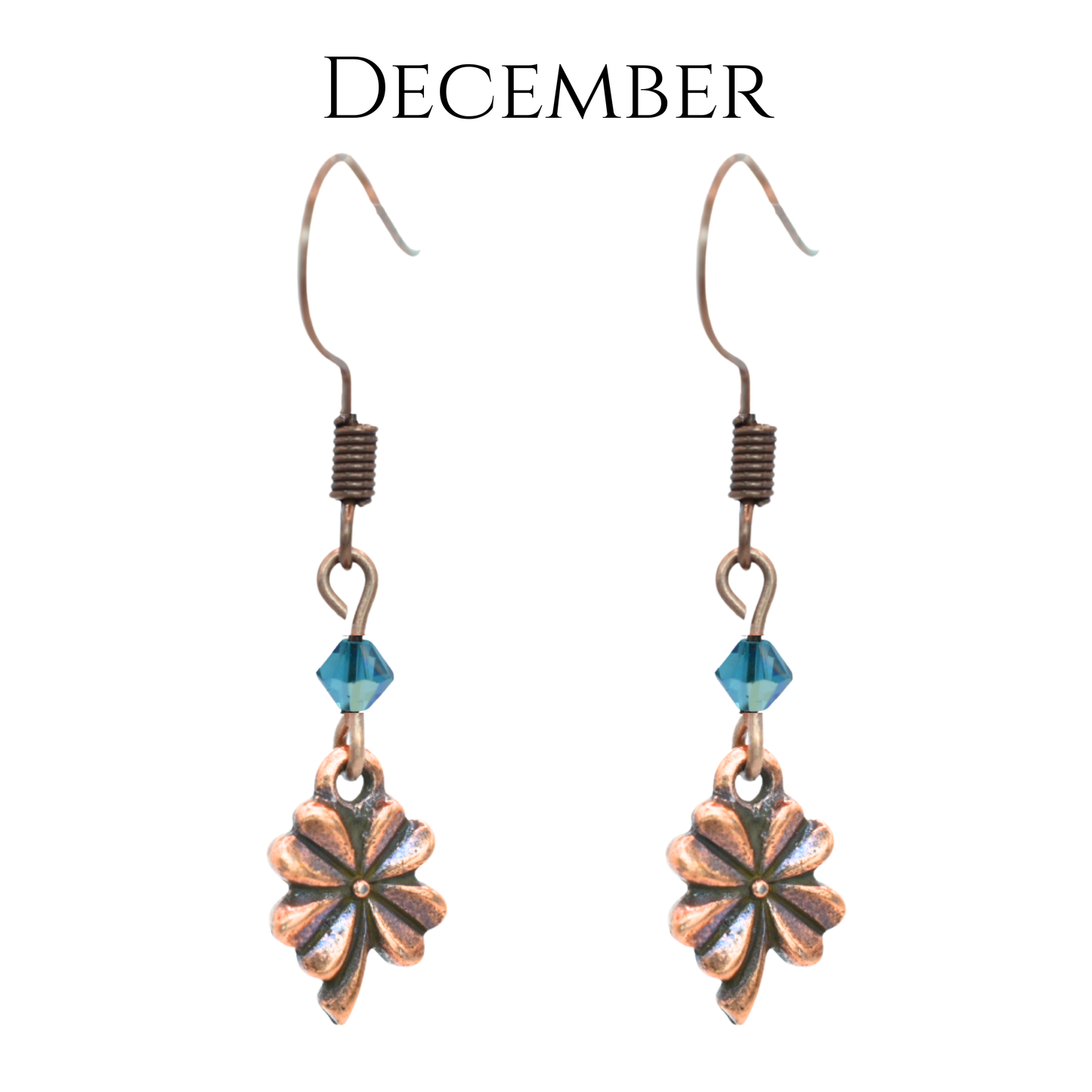 earrings featuring antique copper four leaf clover charms and Austrian crystal beads in December birthstone colors