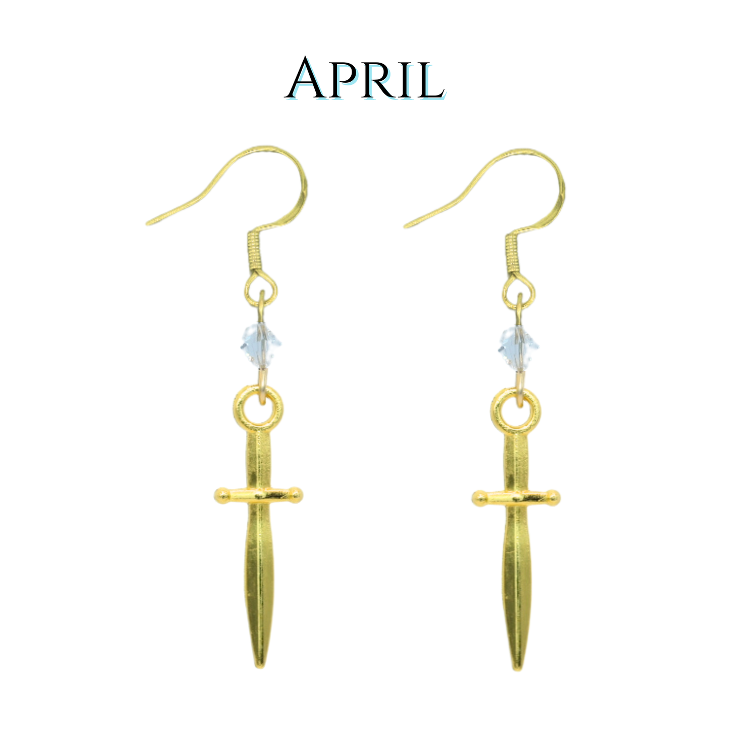 Gold dagger-shaped earrings with a clear crystal beads on a white background, labeled 'April'.