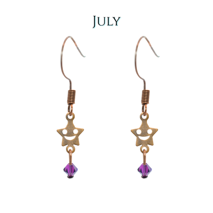 Star-shaped earrings with purple beads on a white background, labeled 'JULY'.