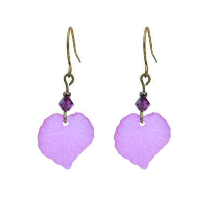 Pair of pink leaf-shaped earrings with fuchsia pink beads on a white background