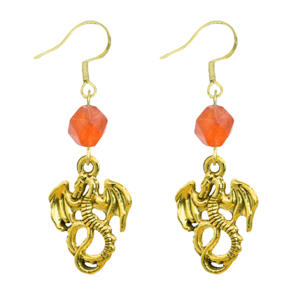 Gold dragon earrings with orange beads on a white background