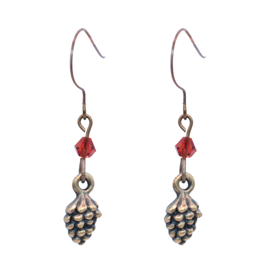 Pair of copper pinecone-shaped earrings with red crystal beads on a white background