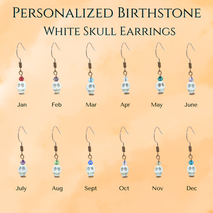 Set of personalized birthstone white skull and crystal bead earrings on a gradient background