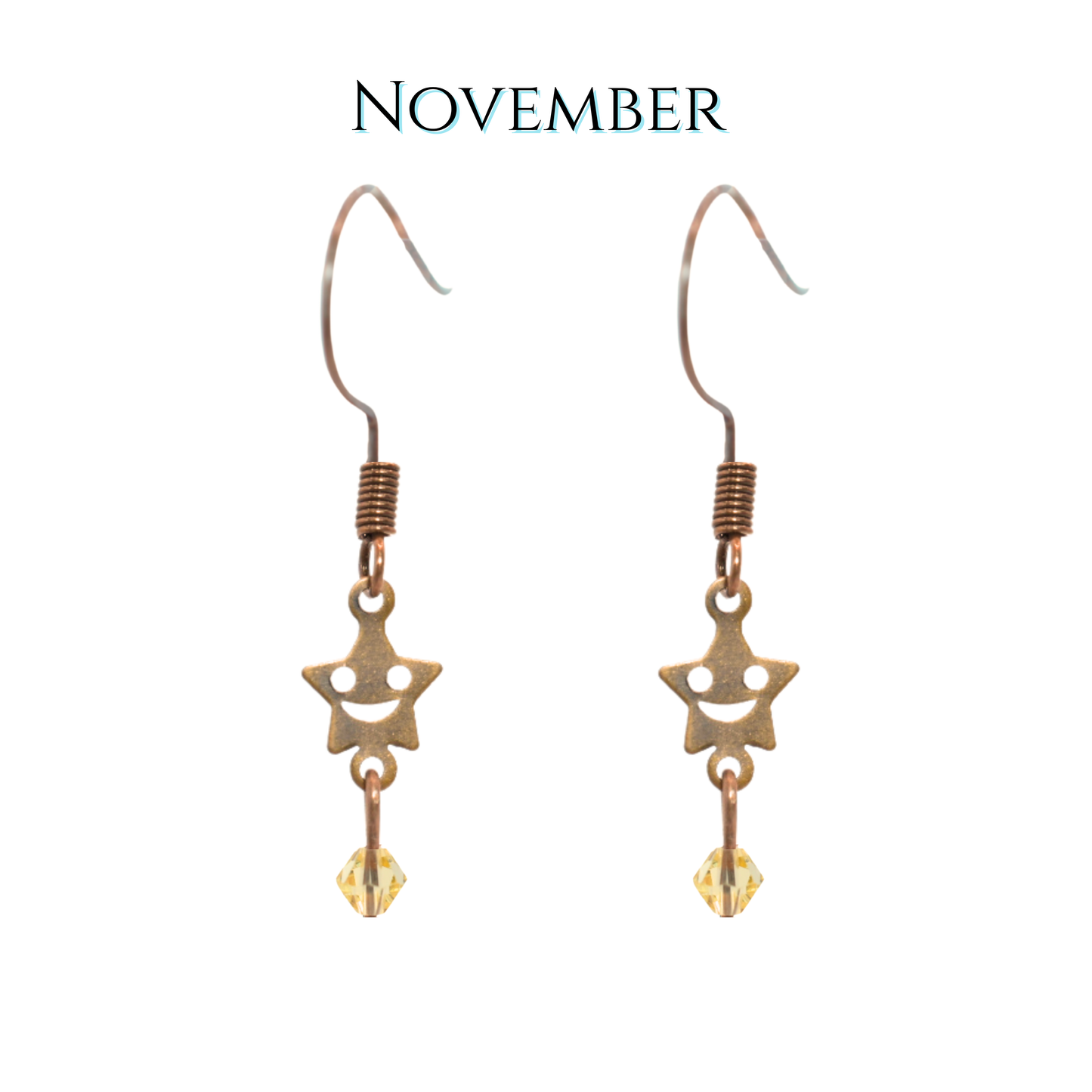 Star-shaped earrings with a topaz crystal on a white background, labeled 'November'.