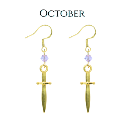Gold dagger-shaped earrings with light pink crystal beads on a white background, labeled 'October'.