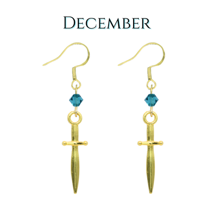 Gold dagger earrings with blue teal crystal beads on a white background, labeled 'December'.