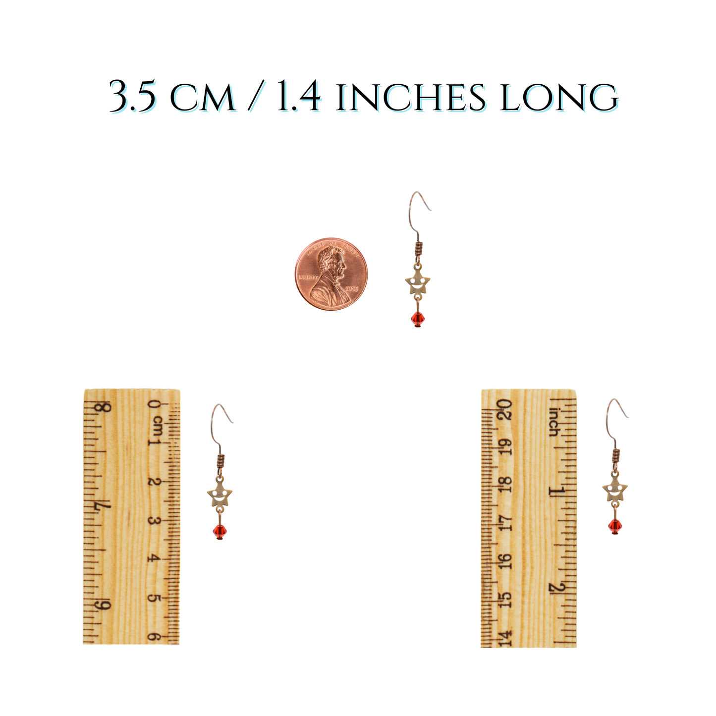 Pair of earrings with a ruler and penny for size reference on a white background