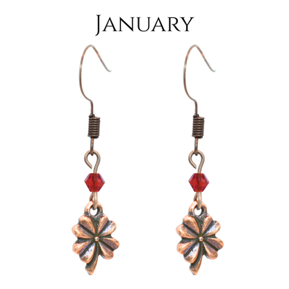 earrings featuring antique copper four leaf clover charms and Austrian crystal beads in January birthstone colors