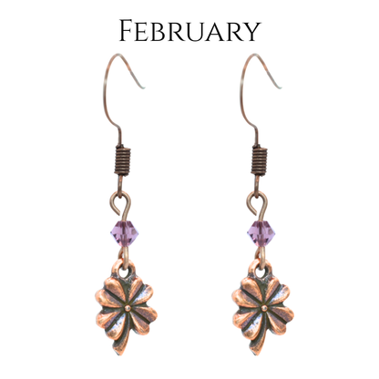 earrings featuring antique copper four leaf clover charms and Austrian crystal beads in February  birthstone colors