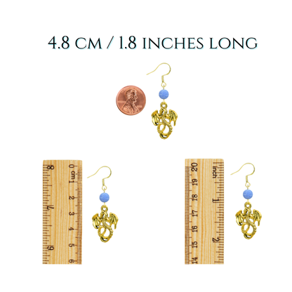 Gold earrings with blue beads on a white background, shown next to a ruler for size reference.