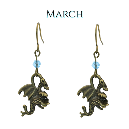 earrings featuring antique bronze dragon charms and blue crystal beads, image has text "March"
