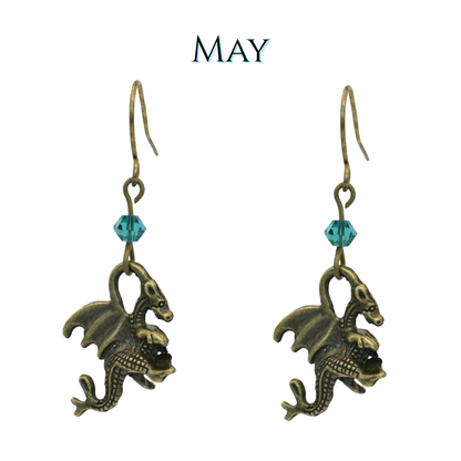 earrings featuring antique bronze dragon charms and green crystal beads, image has text "May"