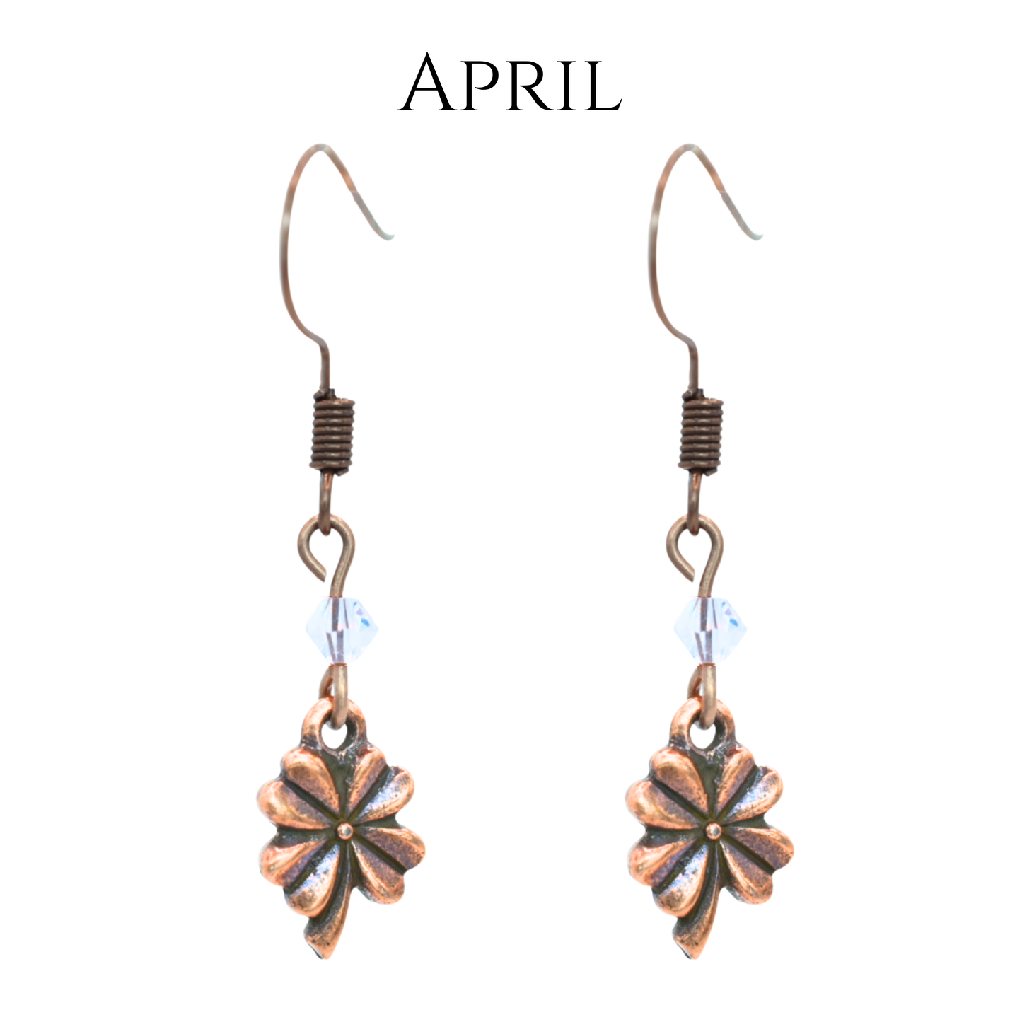 earrings featuring antique copper four leaf clover charms and Austrian crystal beads in April birthstone colors