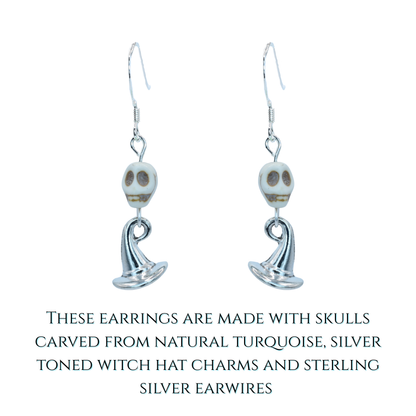 Pair of earrings with skull designs on a white background