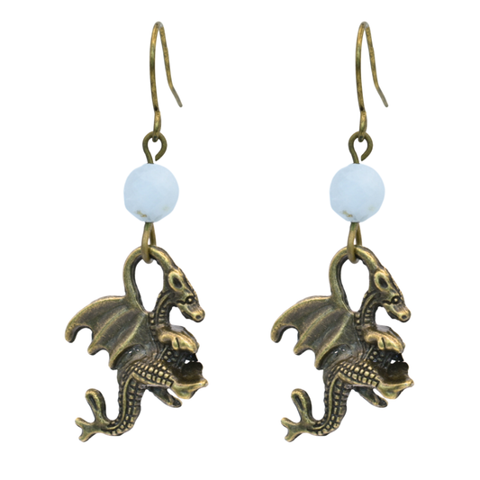 Dragon-shaped earrings with white moonstone beads on a white background