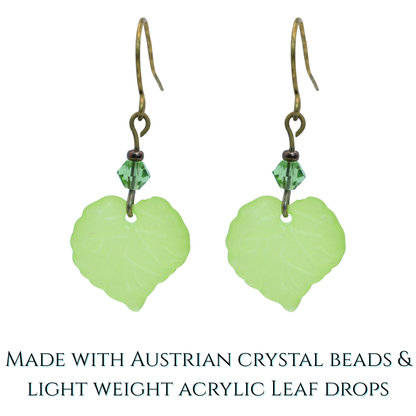 Green leaf-shaped earrings with Austrian crystal beads on a white background