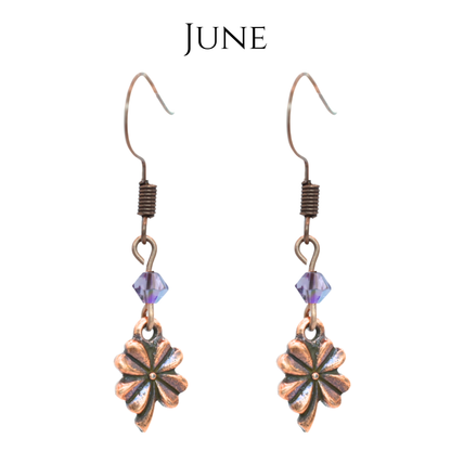 earrings featuring antique copper four leaf clover charms and Austrian crystal beads in June birthstone colors