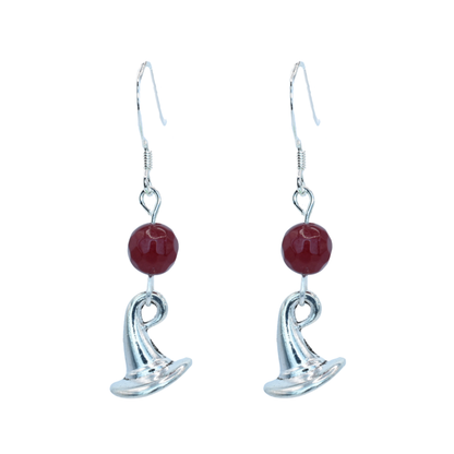 Silver earrings with ruby red jade beads and a wizard hat charm on a white background