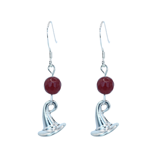 Silver earrings with ruby red jade beads and a wizard hat charm on a white background
