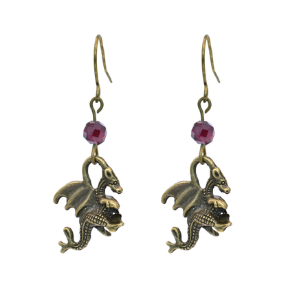 Dragon-shaped earrings with red garnet beads on a white background