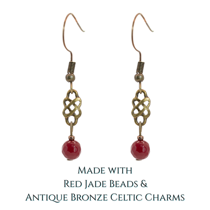 Pair of earrings with red jade beads and antique bronze Celtic charms on a white background.