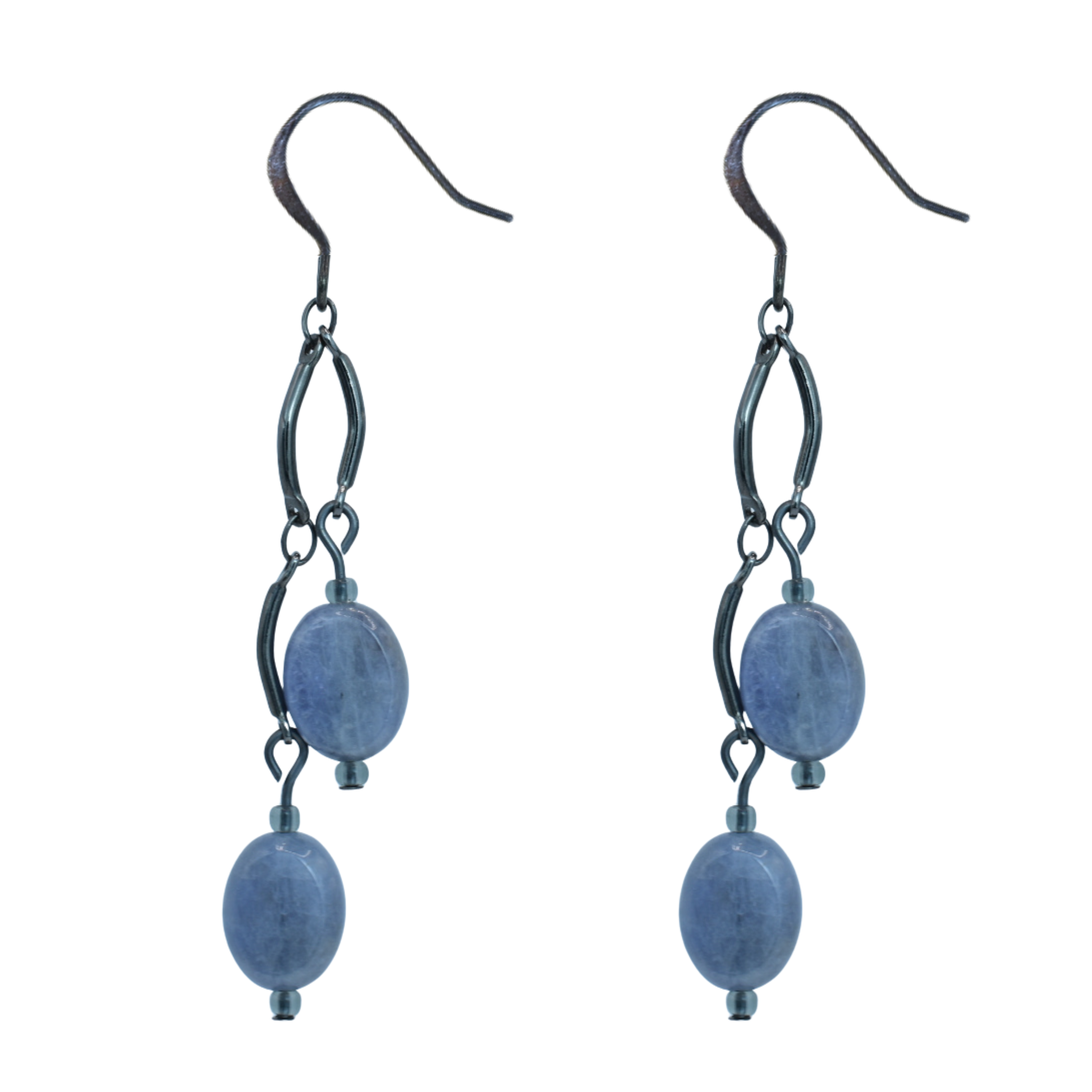 Pair of earrings with tanzanite beads and black metal loops on a white background
