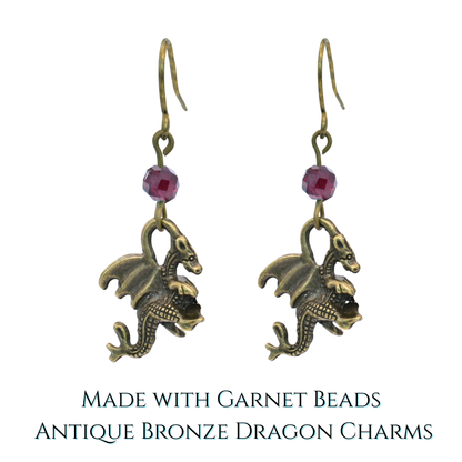 Pair of dragon-shaped earrings with garnet beads on a white background