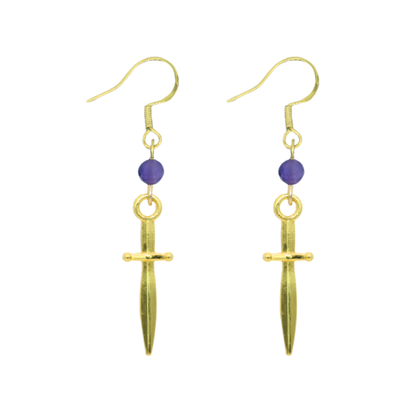 Gold earrings with purple beads on a white background