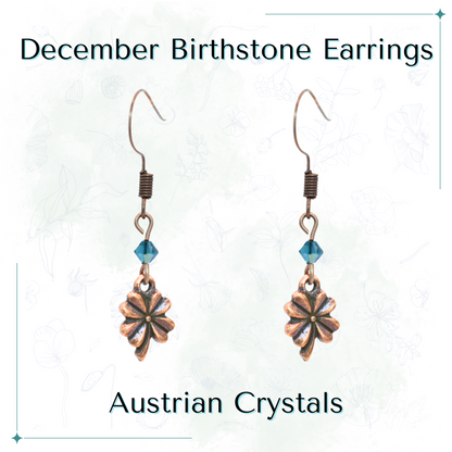 Pair of antique copper four leaf clover earrings with teal Austrian crystals on a white background, labeled 'December Birthstone Earrings'.