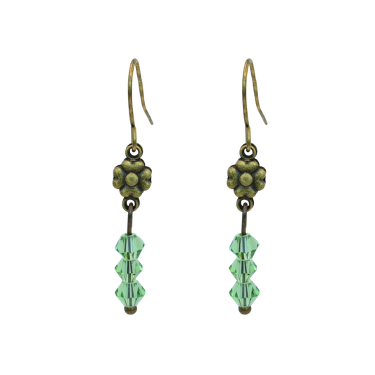 Pair of earrings with green Austrian crystal beads and antique bronze flowers on a white background